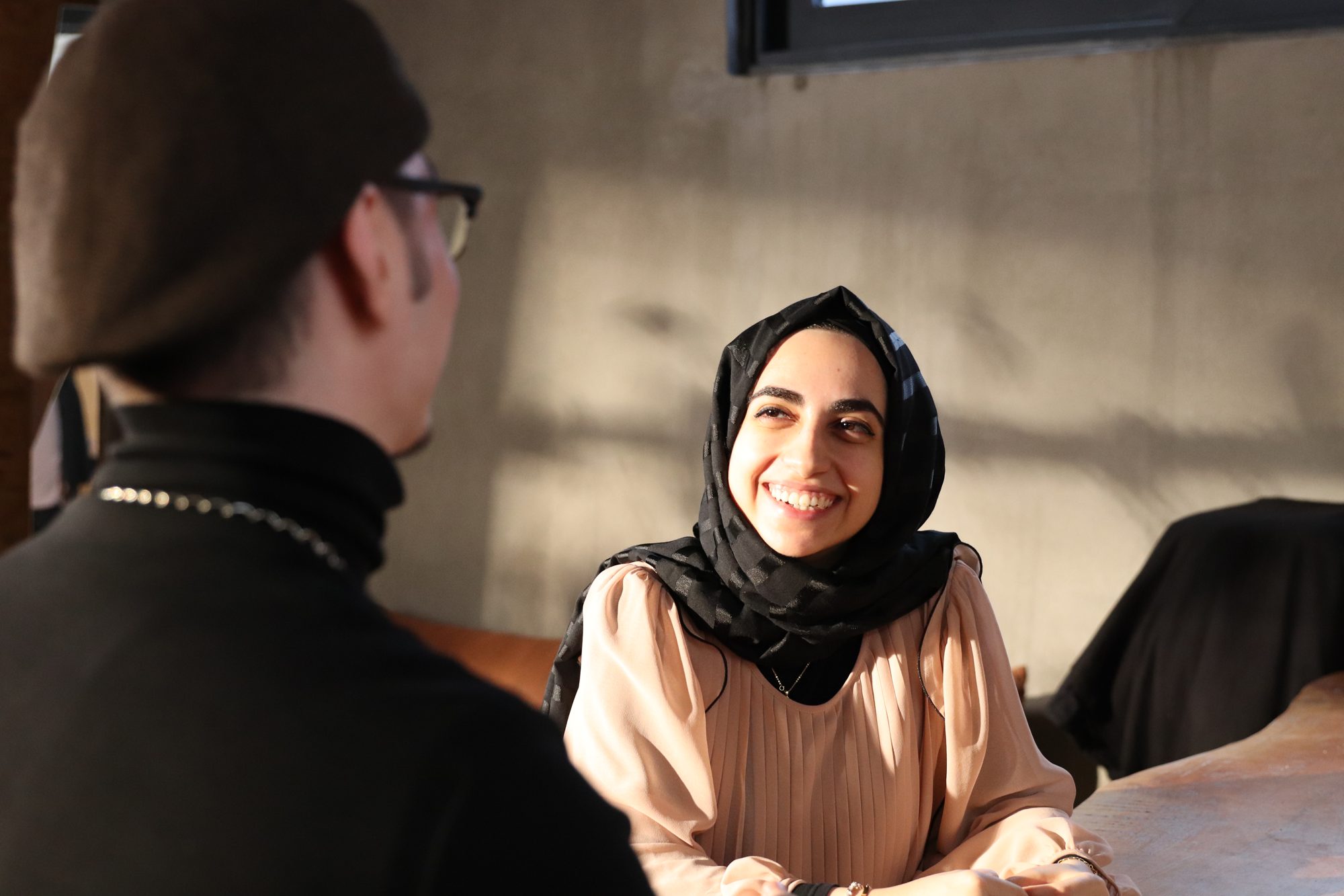 Two Re:Coded learners smiling in conversation