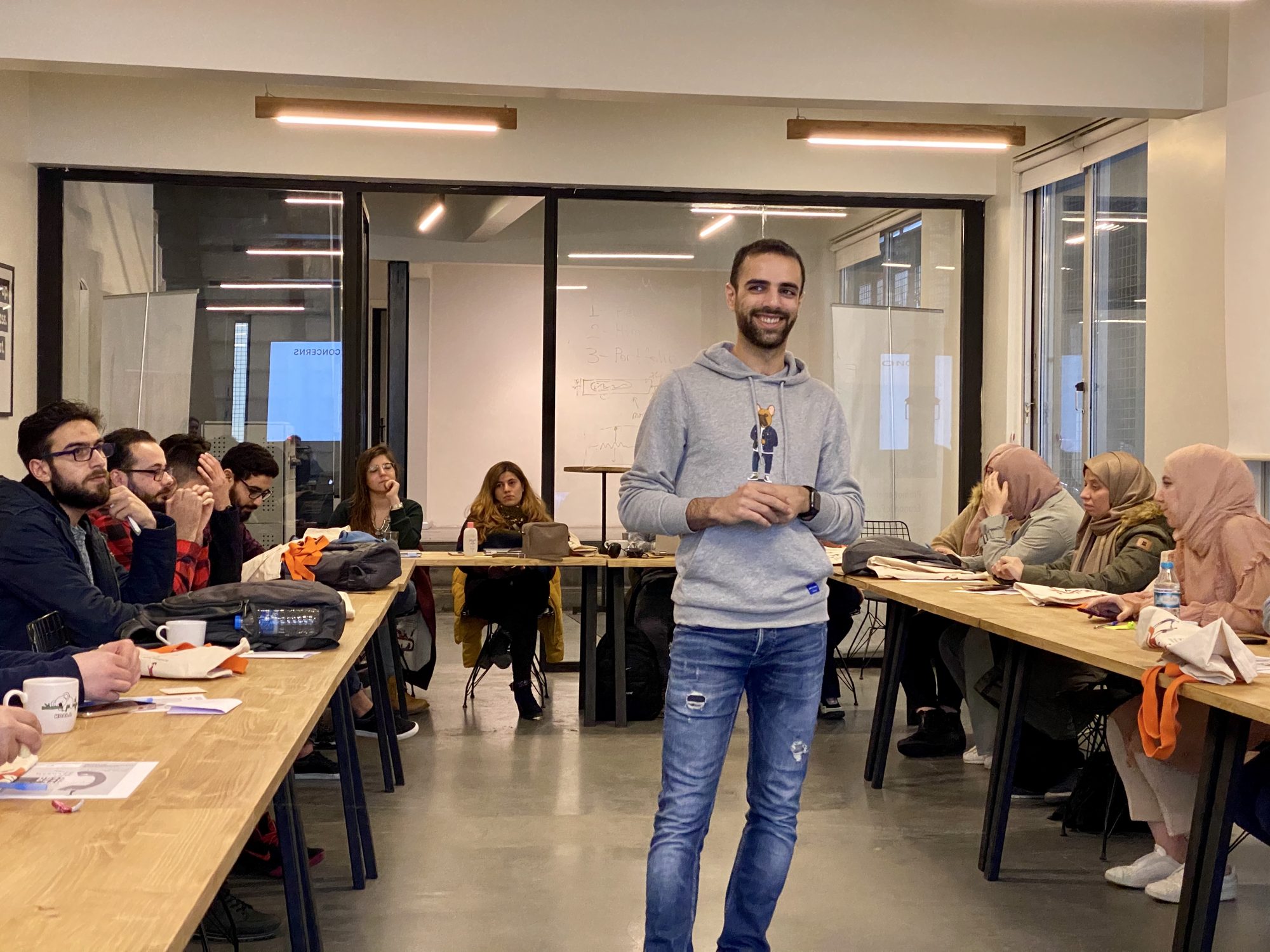 An instructor smiling in front of a class
