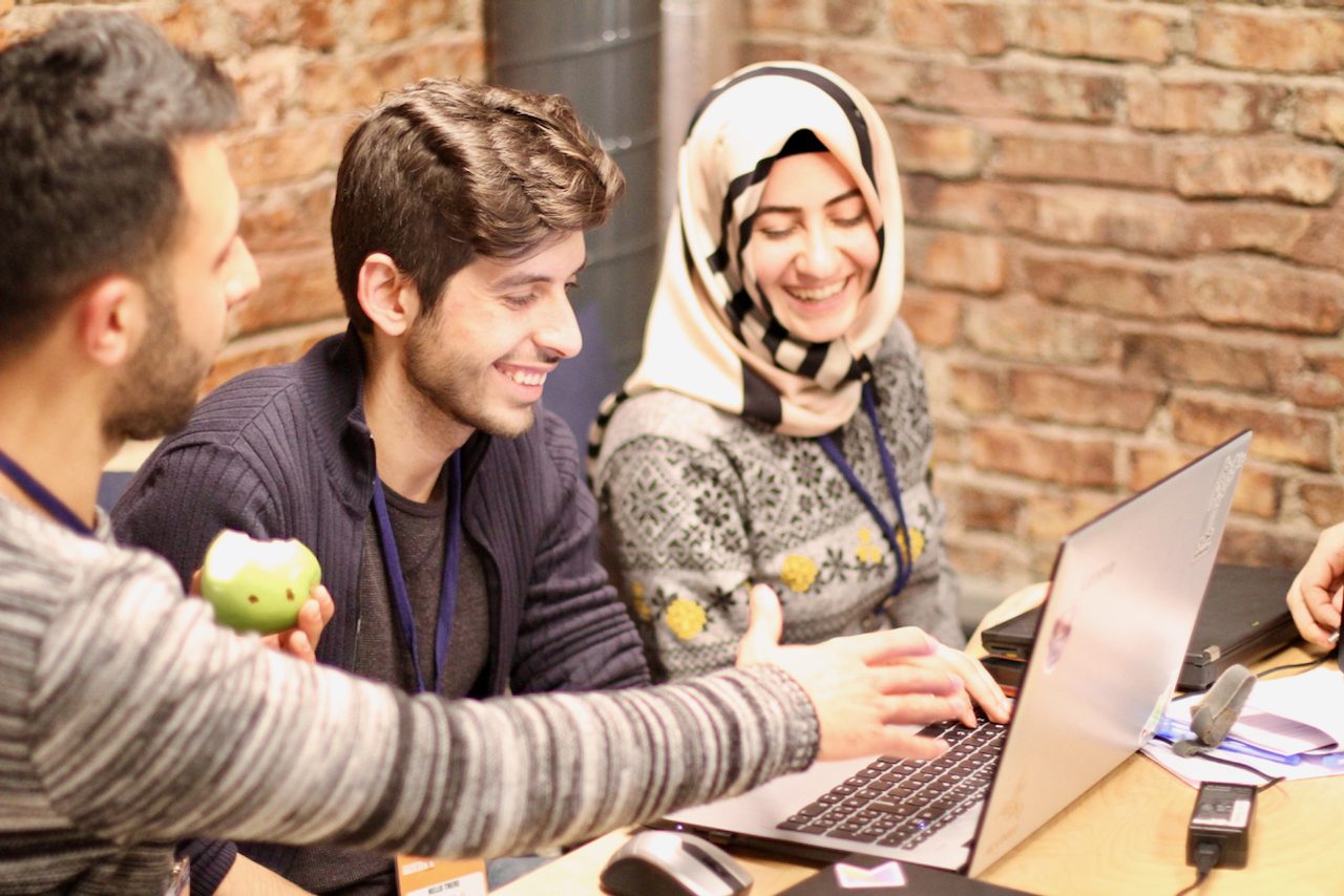 Fellows working together at a hackathon