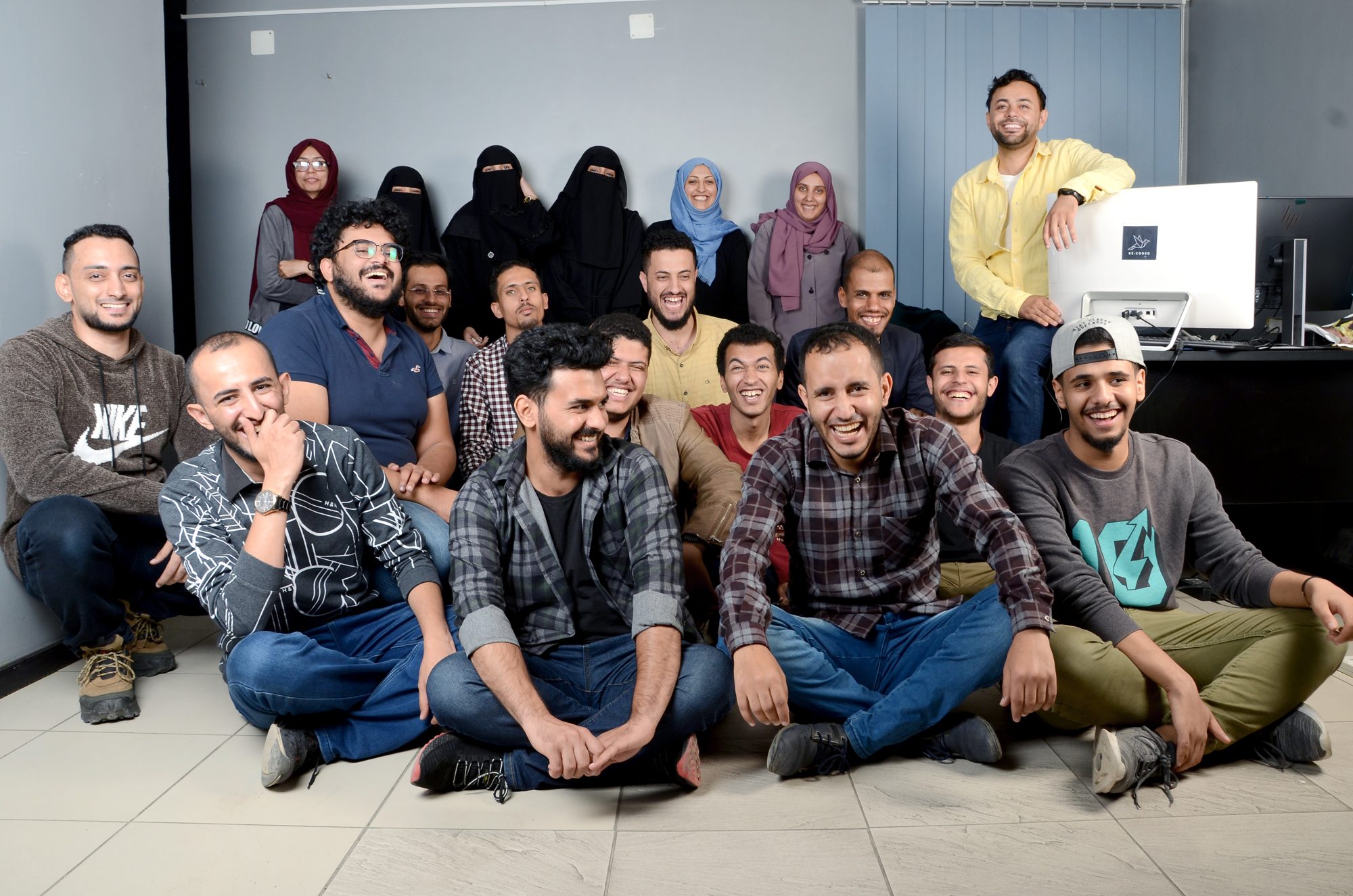 A Re:Coded cohort in Yemen laughing together in their classroom